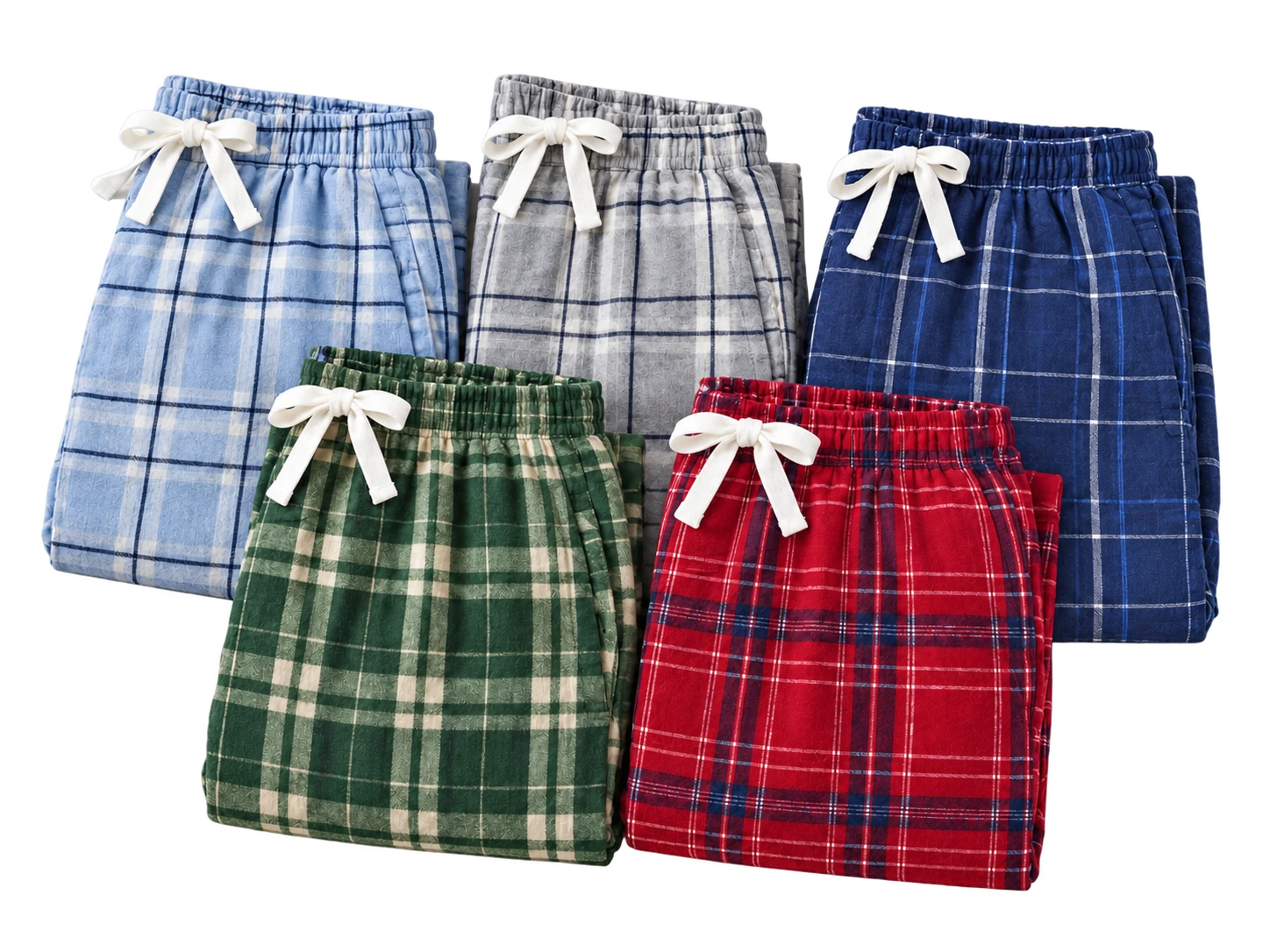 Five folded pairs of Boxercraft flannel pants in blue, gray, navy, forest green and burgundy plaids